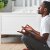 Man practicing meditation at home