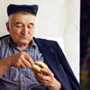 Older man eating fast food while sitting down