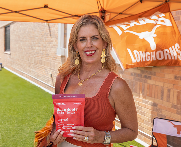 Ellen Manning, mother of Texas quarterback Arch Manning, holding a bag of Humann SuperBeets Heart Chews