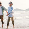 Older couple walking on a beach