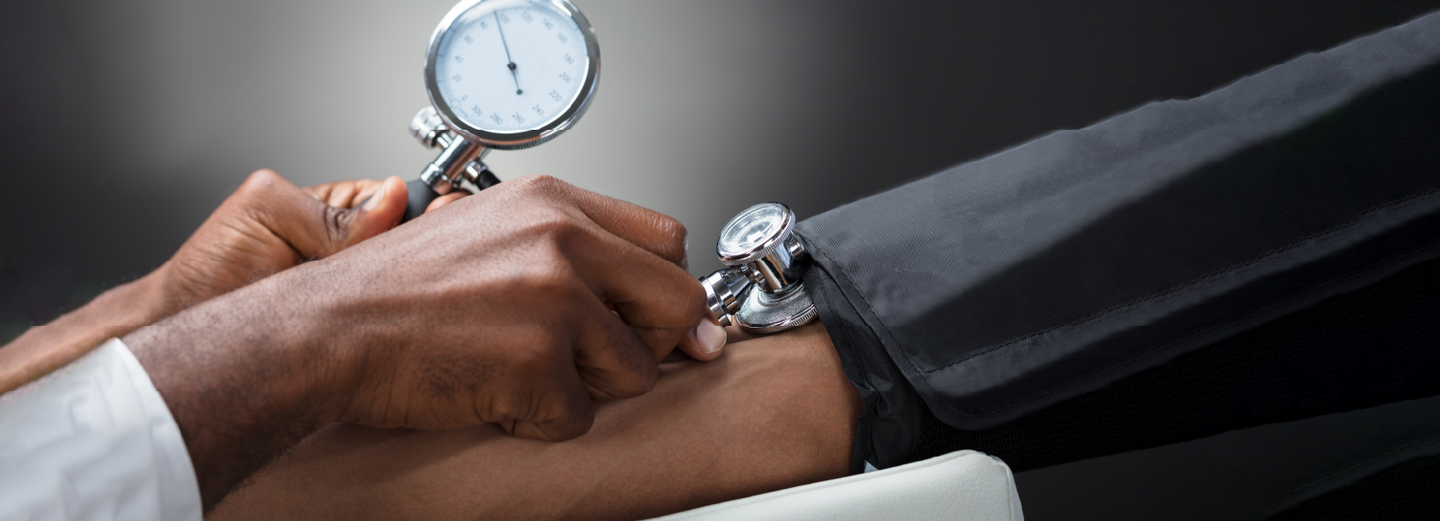 Doctor measuring patient's blood pressure with stethoscope