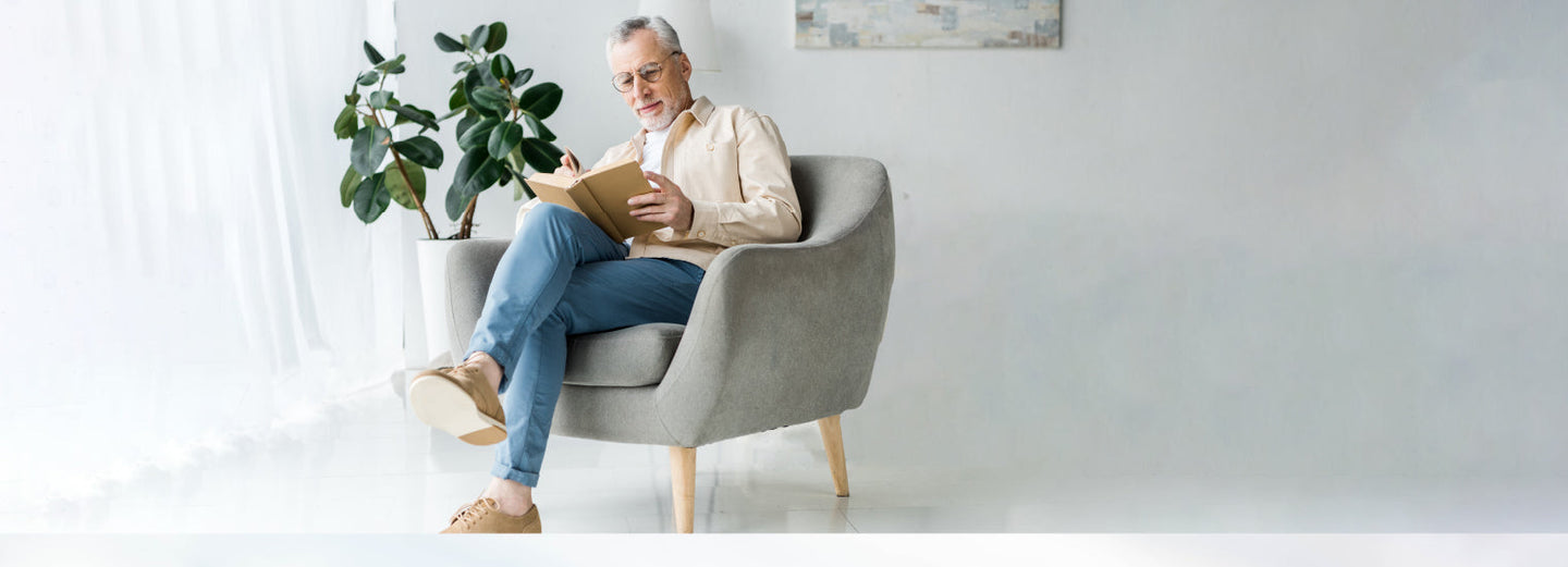 Man reading a book in a chair