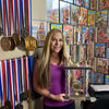 Photo of Fitness Olympia Champion Monica Brant and her awards