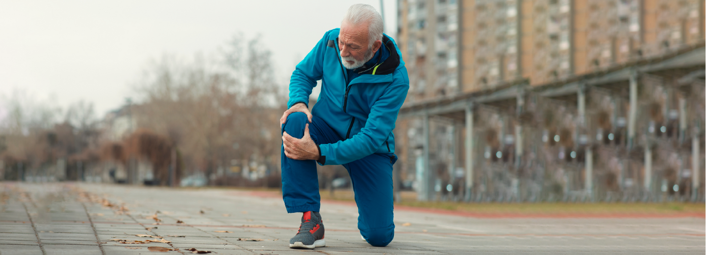 Man holding his knee during a walk