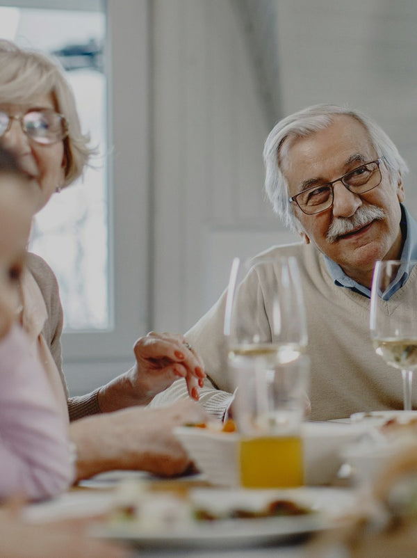 Older couple smiling at a dinner table