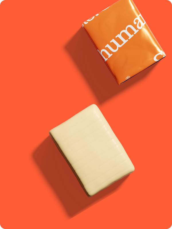 Cholesterol Daily Chew and its wrapper on an orange background