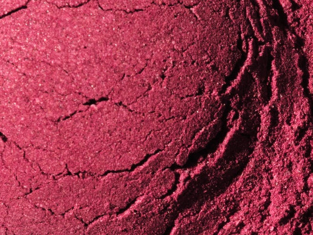 A small mound of bright beet root powder