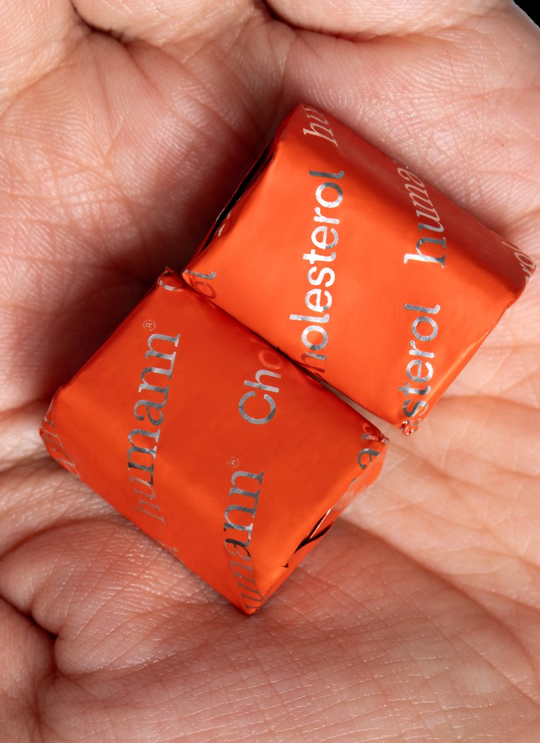 Cholesterol Daily Chews in a hand